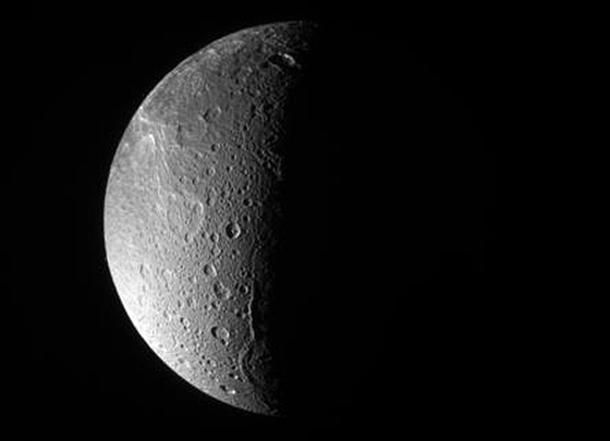 PIA09886 The Cassini spacecraft looks down, almost directly at the north pole of Dione. The feature just left of the terminator at bottom is Janiculum Dorsa, a long, roughly north-south trending ridge. Image credit: NASA/JPL/Space Science Institute.