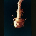 PDP grappled by RMS is positioned above payload bay (PLB) at sunrise