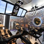 The Dragon V2 spacecraft's seating arrangement with the control panel swung up to allow crewmembers to get into their seats. Once the crew is in place, the control panel swings down and locks in launch position. SpaceX unveiled the new spacecraft during a ceremony at its headquarters in Hawthorne, Calif. The Dragon V2 is designed to carry people into Earth's orbit and was developed in partnership with NASA's Commercial Crew Program under the Commercial Crew Integrated Capability agreement. SpaceX is one of NASA's commercial partners working to develop a new generation of U.S. spacecraft and rockets capable of transporting humans to and from Earth's orbit from American soil. Ultimately, NASA intends to use such commercial systems to fly U.S. astronauts to and from the International Space Station. Photo credit: NASA/Dimitri Gerondidakis