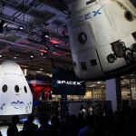 The Dragon V2 stands on a stage inside SpaceX headquarters in Hawthorne, Calif., near a suspended cargo-carrying Dragon spacecraft that flew a previous mission. The new spacecraft, the Dragon V2, is designed to carry people into Earth's orbit and was developed in partnership with NASA's Commercial Crew Program under the Commercial Crew Integrated Capability agreement. SpaceX is one of NASA's commercial partners working to develop a new generation of U.S. spacecraft and rockets capable of transporting humans to and from Earth's orbit from American soil. Ultimately, NASA intends to use such commercial systems to fly U.S. astronauts to and from the International Space Station. Photo credit: NASA/Dimitri Gerondidakis